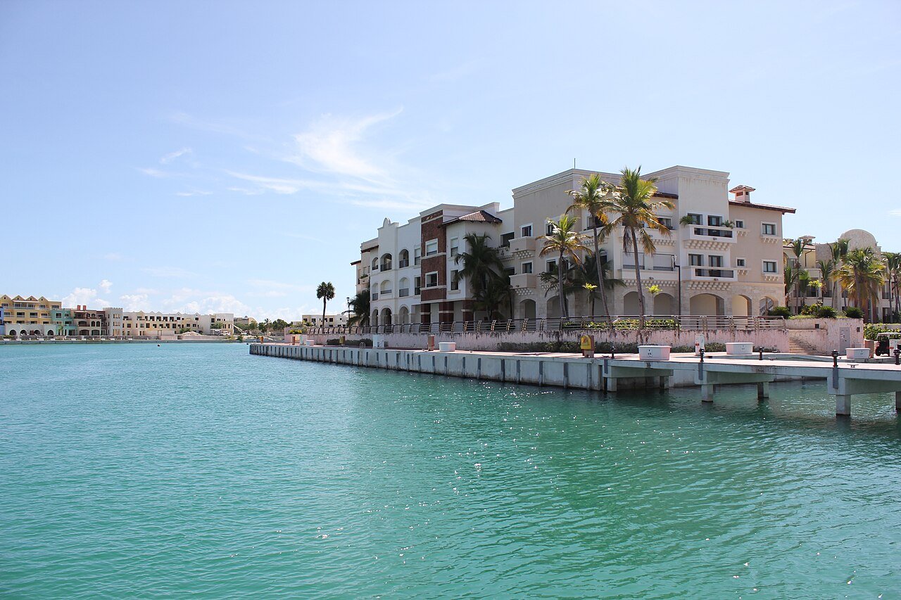 Residences and palm trees beside Cap Cana marina